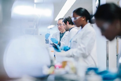 Chemists examining test tubes in a laboratory